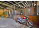 Barn aisle with partial view of stalls and motorcycle at 460 Dixie Rd, Covington, GA 30014