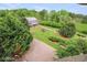 Elevated view showcasing home, barn, and expansive landscaped backyard at 460 Dixie Rd, Covington, GA 30014
