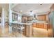 Kitchen with island, wood cabinets, and granite counters at 460 Dixie Rd, Covington, GA 30014