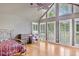 Bright bedroom with hardwood floors, large windows, and a ceiling fan at 460 Dixie Rd, Covington, GA 30014