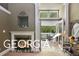 Bright bedroom with fireplace, access to private deck, and relaxing views at 460 Dixie Rd, Covington, GA 30014