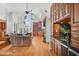 Spacious living room with stone fireplace, built-in shelving, and hardwood floors at 460 Dixie Rd, Covington, GA 30014