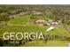Aerial view of a spacious property with horse riding areas and large fields at 460 Dixie Rd, Covington, GA 30014