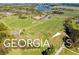 Aerial view of property with large home, equestrian facilities, and open fields at 460 Dixie Rd, Covington, GA 30014