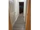 Long hallway with wood-look flooring leading to a bedroom at 3806 London Dr, Decatur, GA 30032