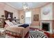 Well-lit bedroom with hardwood floors, fireplace and large painting at 2204 Monticello St, Covington, GA 30014