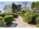 Stone path through manicured gardens leads to a pergola at 2204 Monticello St, Covington, GA 30014