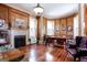 Home office with hardwood floors, wood paneling, and a fireplace at 2204 Monticello St, Covington, GA 30014