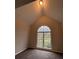 Bright bedroom featuring a large arched window and grey carpet at 3541 Gleneagles Ct, Snellville, GA 30039