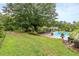 Relaxing pool area with patio furniture and landscaping at 2398 Maddox Rd, Buford, GA 30519