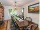 Formal dining room with long wood table and black chairs at 2398 Maddox Rd, Buford, GA 30519