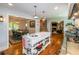 Open concept kitchen with island and view into dining room at 2398 Maddox Rd, Buford, GA 30519