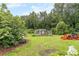 Spacious backyard with shed, chicken coop, and a small tractor at 2398 Maddox Rd, Buford, GA 30519