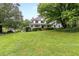 Two-story white house with a large green lawn at 2398 Maddox Rd, Buford, GA 30519