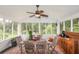 Relaxing screened porch with wooden furniture and ceiling fan at 2398 Maddox Rd, Buford, GA 30519