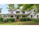 Two-story white farmhouse with wrap-around porch at 2398 Maddox Rd, Buford, GA 30519