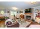 Spacious living room features a brick fireplace, hardwood floors, and ample seating at 2398 Maddox Rd, Buford, GA 30519