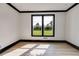 Bright bedroom with two windows and dark wood flooring at 604 N Van Wert N Rd, Villa Rica, GA 30180