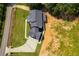 Aerial view of a modern farmhouse with a large backyard and paved driveway at 604 N Van Wert N Rd, Villa Rica, GA 30180