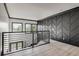 Upper hallway with dark accent wall and metal railing at 604 N Van Wert N Rd, Villa Rica, GA 30180