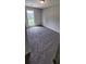 Well-lit bedroom featuring neutral walls and carpet at 6050 April Dr, Sugar Hill, GA 30518