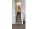 Carpeted staircase leading to the upper level at 6050 April Dr, Sugar Hill, GA 30518