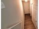 Upstairs hallway with light neutral walls and wood-look flooring at 6050 April Dr, Sugar Hill, GA 30518