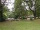 Image shows a backyard with lush trees and a shed at 4144 Janice Dr, Atlanta, GA 30337