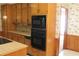 Kitchen features wood cabinets, built-in microwave, and double oven at 3409 Camp Branch Rd, Buford, GA 30519