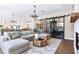 Spacious living area with hardwood floors, sectional sofa, and open floor plan at 121 Villanueva Rd, Woodstock, GA 30188