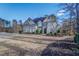House with stone and brick facade, long driveway, and mature trees at 5270 Serenity Sw Ln, Atlanta, GA 30349