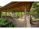 Relaxing pergola with seating overlooking tennis courts at 1827 Lost Mountain Rd, Powder Springs, GA 30127