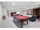 Finished basement with pool table, seating area, and brick fireplace at 1827 Lost Mountain Rd, Powder Springs, GA 30127