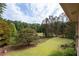 Landscaped backyard with a tennis court and expansive lawn at 1827 Lost Mountain Rd, Powder Springs, GA 30127