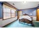 Charming bedroom with wood bed frame and blue carpeting at 1827 Lost Mountain Rd, Powder Springs, GA 30127