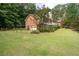 Brick house exterior with attached garage and mature landscaping at 1827 Lost Mountain Rd, Powder Springs, GA 30127