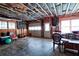 Unfinished basement garage area with tools and furniture at 1827 Lost Mountain Rd, Powder Springs, GA 30127