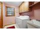 Laundry room with washer, dryer, and utility sink at 1827 Lost Mountain Rd, Powder Springs, GA 30127
