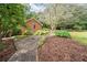 Brick walkway leading to a spacious side yard with landscaping at 1827 Lost Mountain Rd, Powder Springs, GA 30127