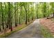 Long driveway leading to home through lush woods at 1827 Lost Mountain Rd, Powder Springs, GA 30127