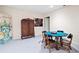 Basement game room with card table, antique cabinet, and artwork at 1827 Lost Mountain Rd, Powder Springs, GA 30127