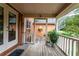 Screened back porch with wooden flooring and surrounding nature views at 1827 Lost Mountain Rd, Powder Springs, GA 30127