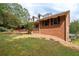 Brick house with a long side porch, showcasing the backyard at 1827 Lost Mountain Rd, Powder Springs, GA 30127