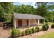 Detached storage shed with double doors and covered porch at 1827 Lost Mountain Rd, Powder Springs, GA 30127