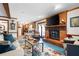 Living room with fireplace, comfortable seating, and large TV at 1827 Lost Mountain Rd, Powder Springs, GA 30127
