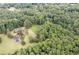 Aerial view showing house, expansive yard, tennis court, and wooded area at 1827 Lost Mountain Rd, Powder Springs, GA 30127