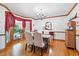 Bright dining room with hardwood floors and a charming chandelier at 1827 Lost Mountain Rd, Powder Springs, GA 30127