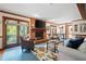 Spacious living room featuring a brick fireplace and hardwood floors at 1827 Lost Mountain Rd, Powder Springs, GA 30127