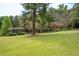 Large backyard with a detached structure and mature trees at 1827 Lost Mountain Rd, Powder Springs, GA 30127