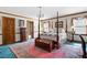 Main bedroom with four-poster bed, and wood dresser at 1827 Lost Mountain Rd, Powder Springs, GA 30127